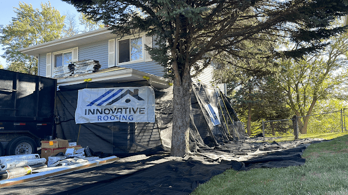 Innovative Roofing job site with branded banner